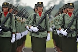 Female Indonesian soldiers stand in formation during a military ceremony