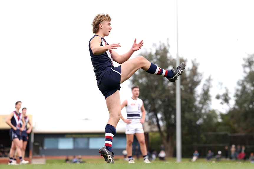 Ryley Sanders follows through after kicking the ball