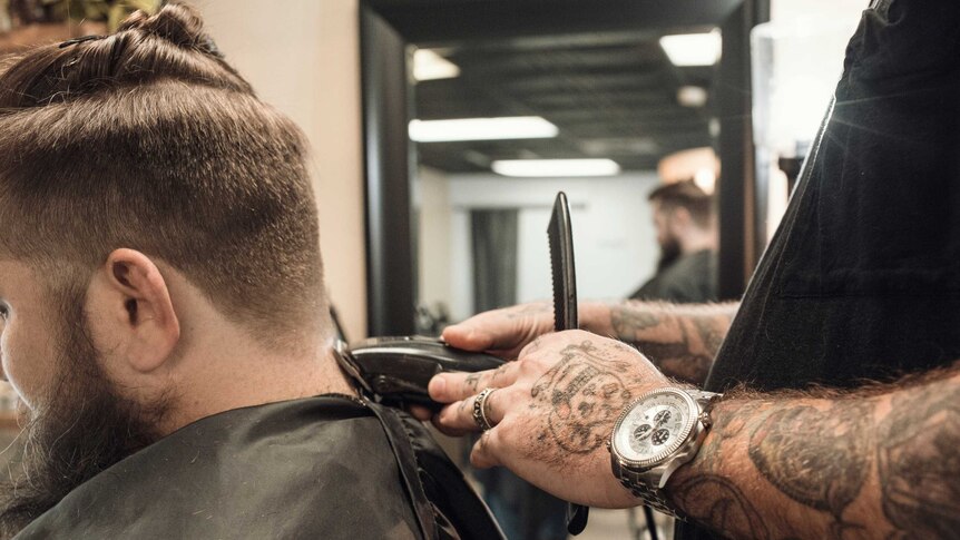 Man having beard shaved