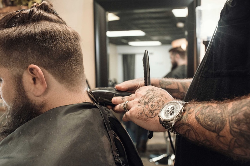 Man having beard shaved