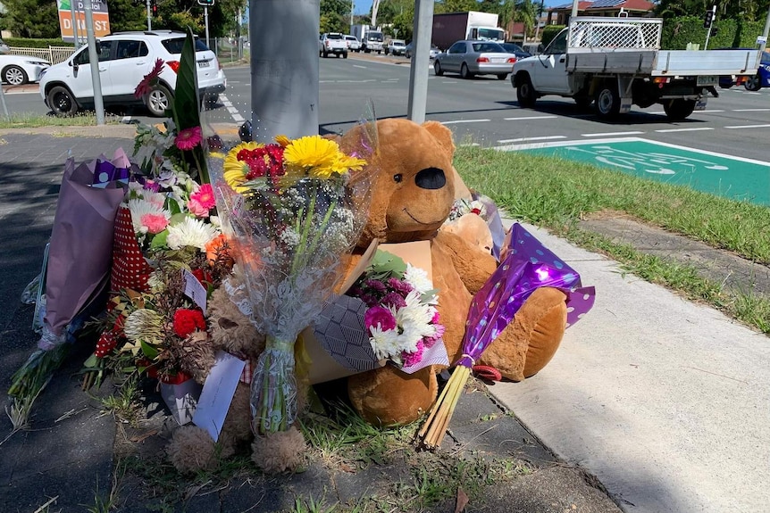 Flowers and a big teddy bear laid at the scene of the fatal crash at Alexandra Hills, east of Brisbane.