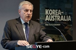 A man speaks at a lectern