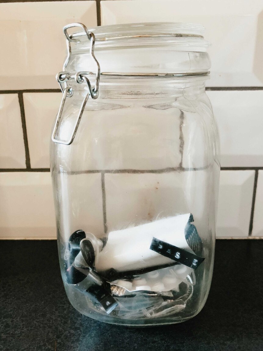 Jar with dog collar and other rubbish