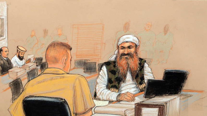 Khalid Sheikh Mohammed, (R), the alleged mastermind of the September 11 attacks, speaks with his defence lawyer