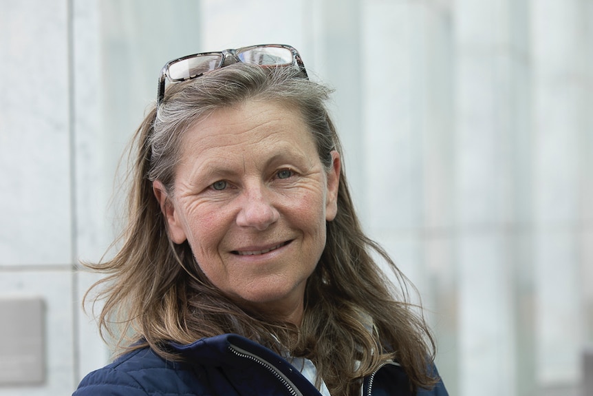 A woman smiles at the camera.