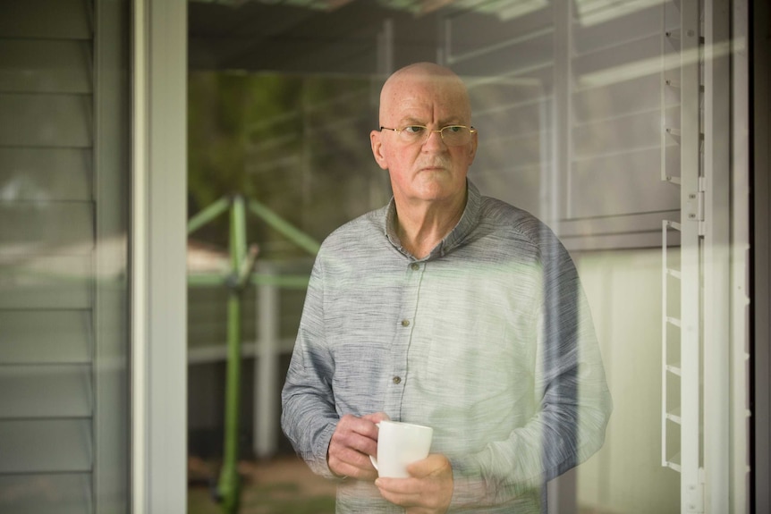 Stephen Cook looks out at his garden from inside his house in Penrith.