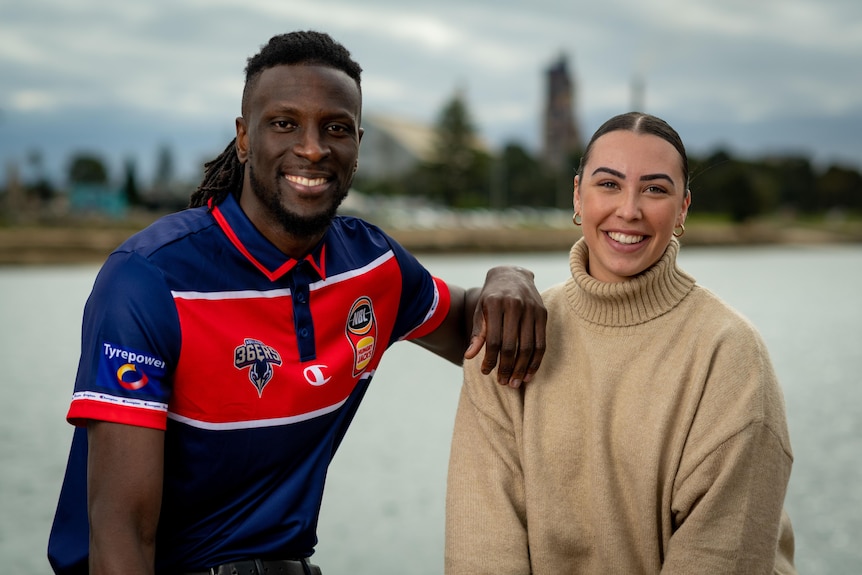 A basketballer with his partner on the Port Adelaide waterfront.