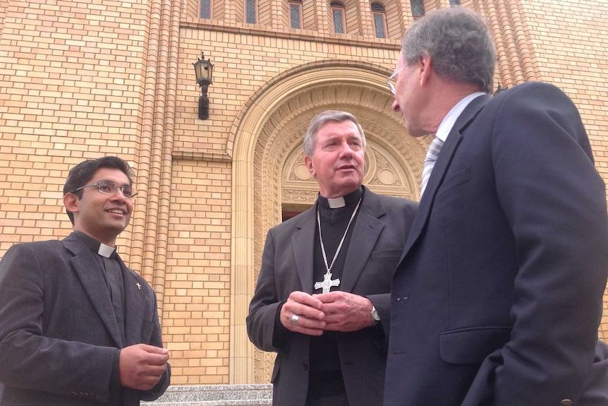 Archbishop Christopher Prowse in front on St Christopher's Cathedral