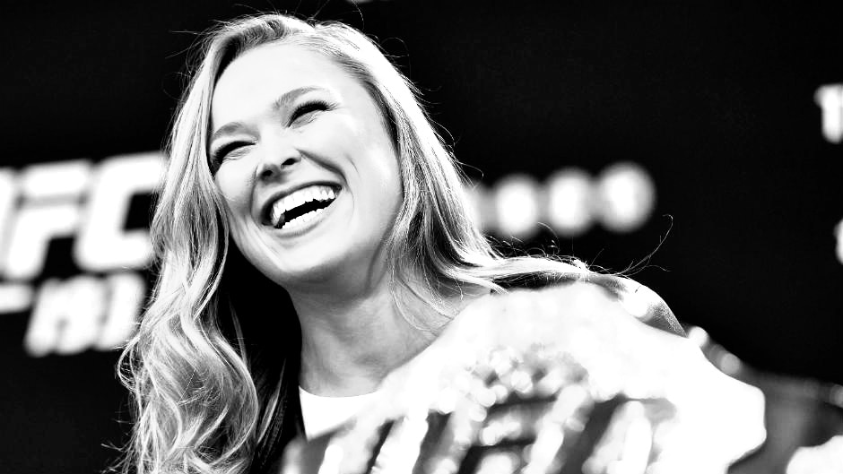 Ronda Rousey smiling at a press conference.