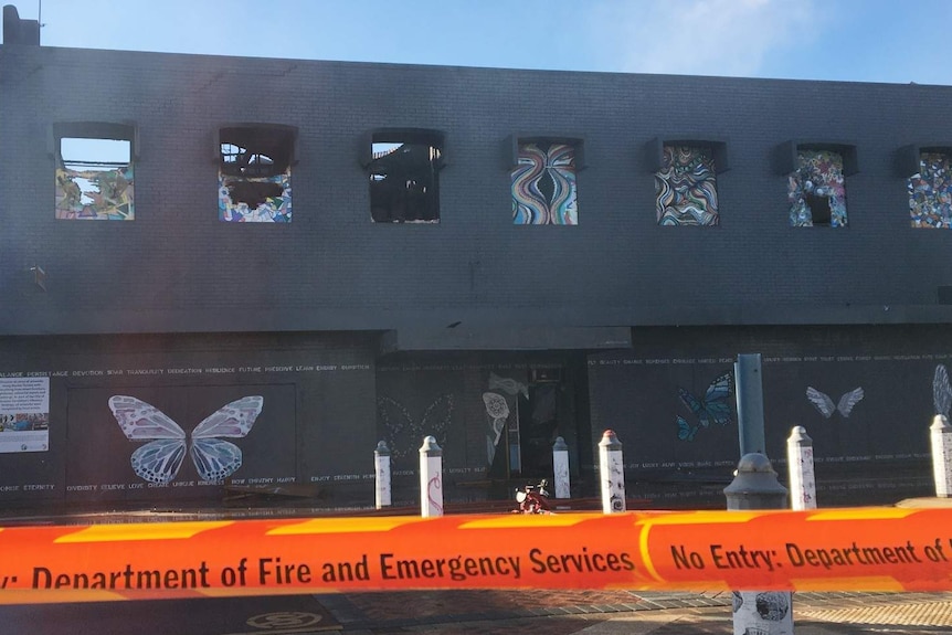 Broken windows at a building destroyed by fire