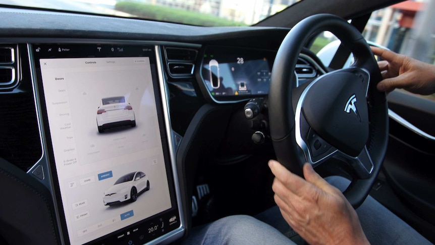 The dashboard and digital screen of a Tesla electric car, which is powered by lithium batteries.