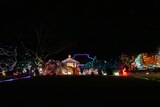 A house and garden with thousands of fairy lights, all different colours.