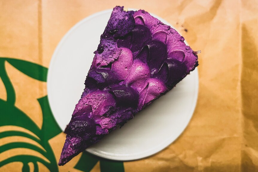 A slice of cake with bright purple icing