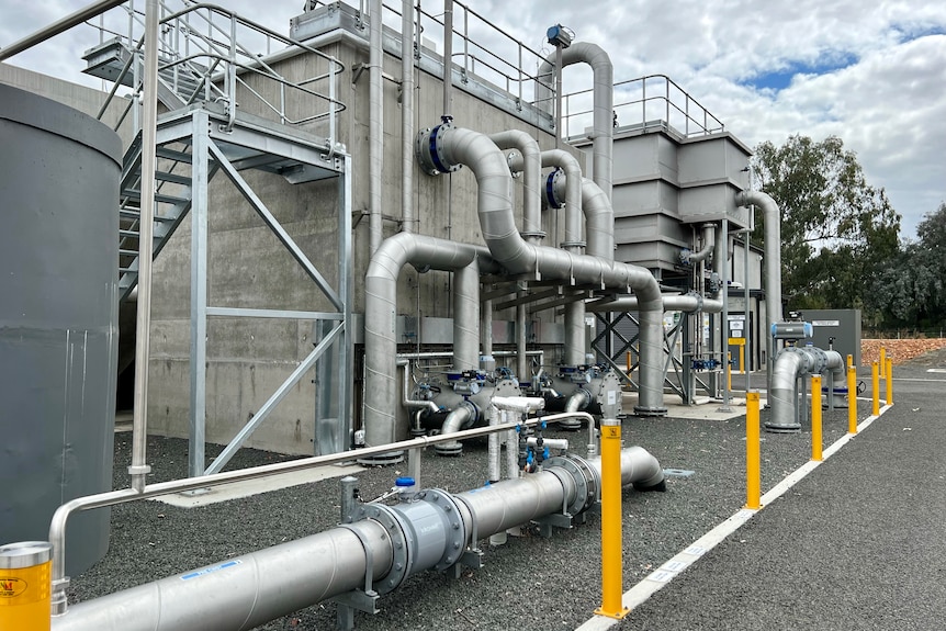 A series of stainless steel pipes, stairs and tanks