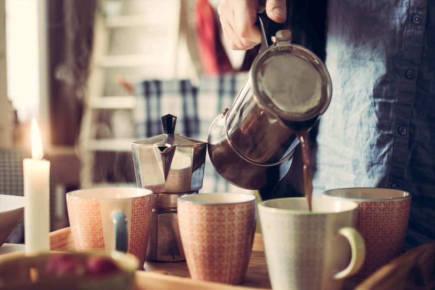 Coffee being poured into several mugs to depict the role caffeine can and cannot play in sleep problems.