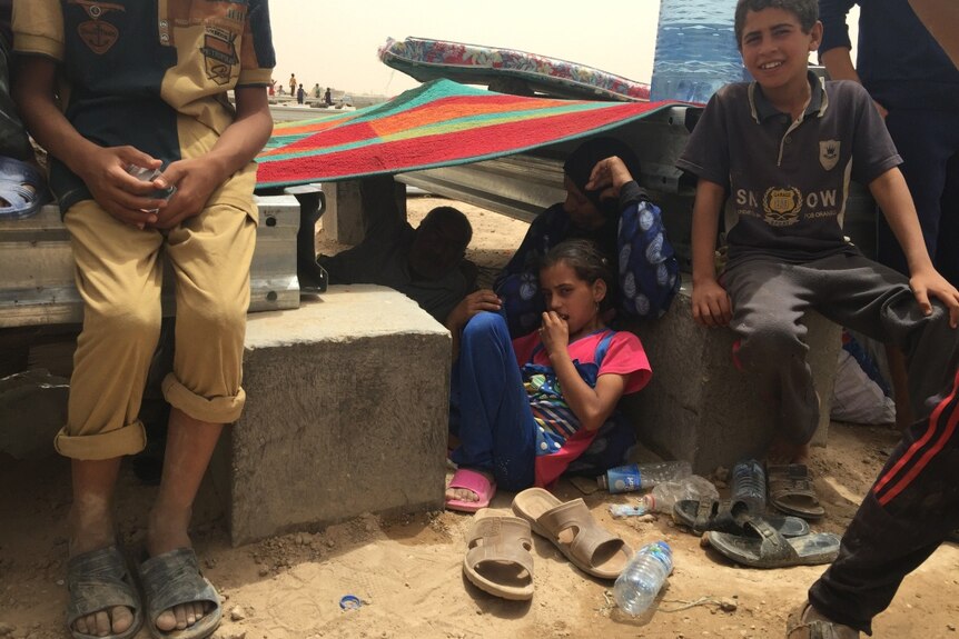 A family with a young girl in Amariyat Al Fallujah camp.