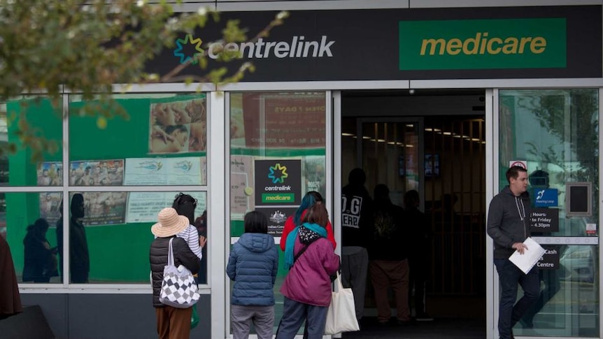 People line up outside a Centrelink office in Melbourne in March 2020