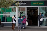 People line up outside a Centrelink office in Melbourne in March 2020