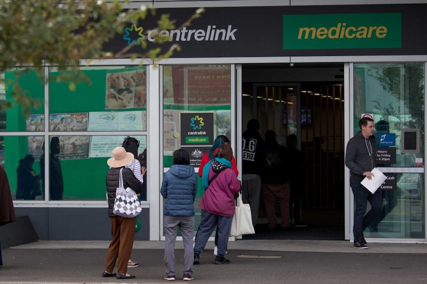 People line up outside a Centrelink office in Melbourne in March 2020