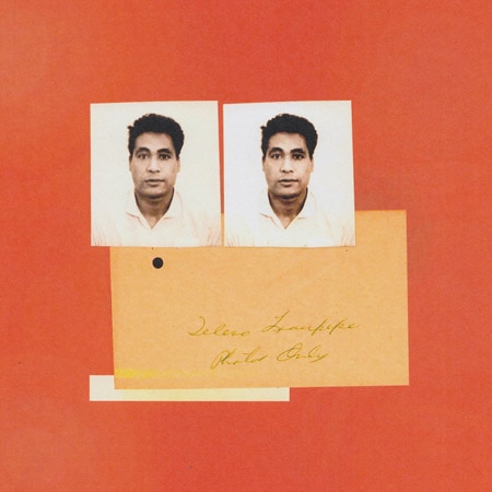 Two passport photos of a man and a bright orange note before a reddish-orange background.