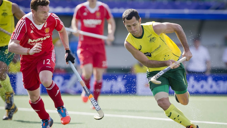 Australia's Jamie Dwyer (R) on the ball against England at the men's Hockey World Cup in June 2014.