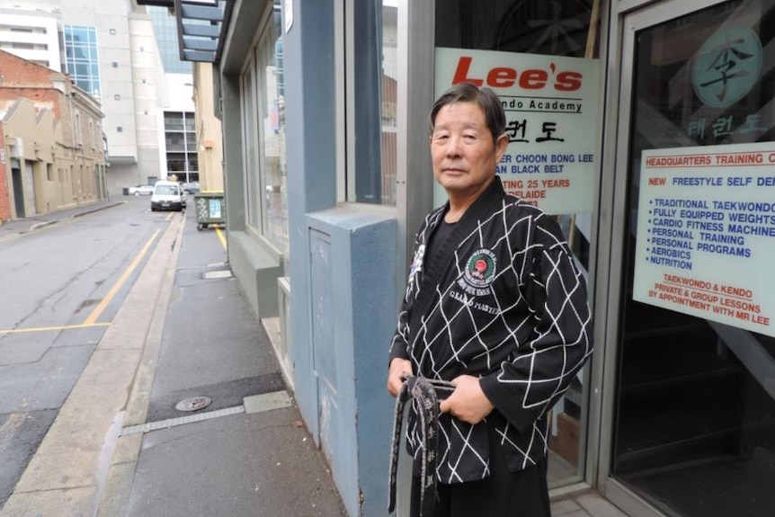 Mr Lee standing outside his Taekwondo business on Hyde Street in Adelaide's CBD