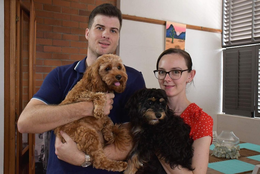 A man and woman with their pet dog