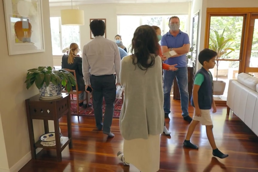 People looking at 26 Cadiz Street, Indooroopilly, which sold at auction