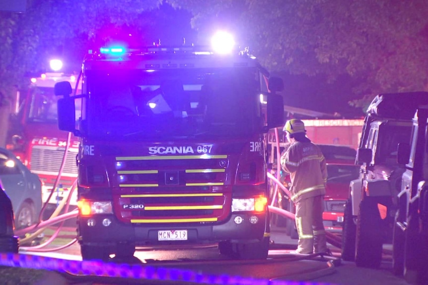 A fire truck on a suburban street at night.