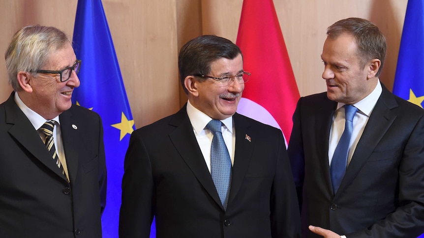 Turkish Prime Minister Ahmet Davutoglu is welcomed by EU leaders.