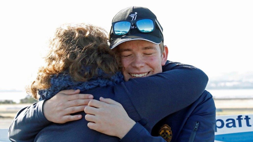 Teenage solo pilot Oliver O'Halloran hugs his mother
