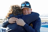 Teenage solo pilot Oliver O'Halloran hugs his mother