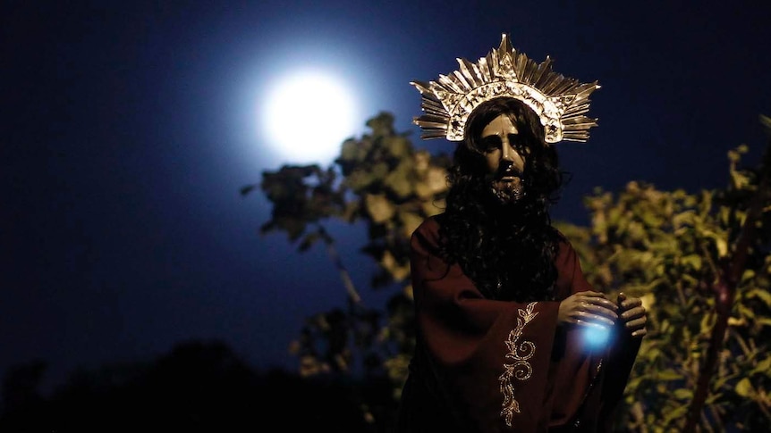 Catholics carry a statue of Jesus Christ during an Easter procession