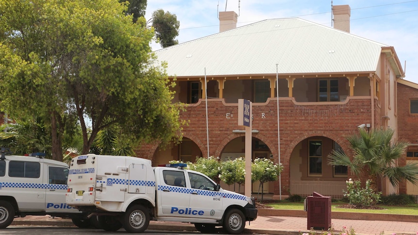 Broken Hill's police station with police vehicles out the front