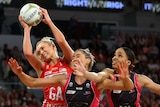 Netballers compete for the ball