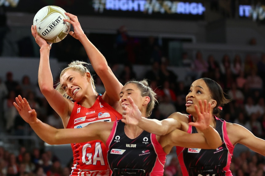Netballers compete for the ball