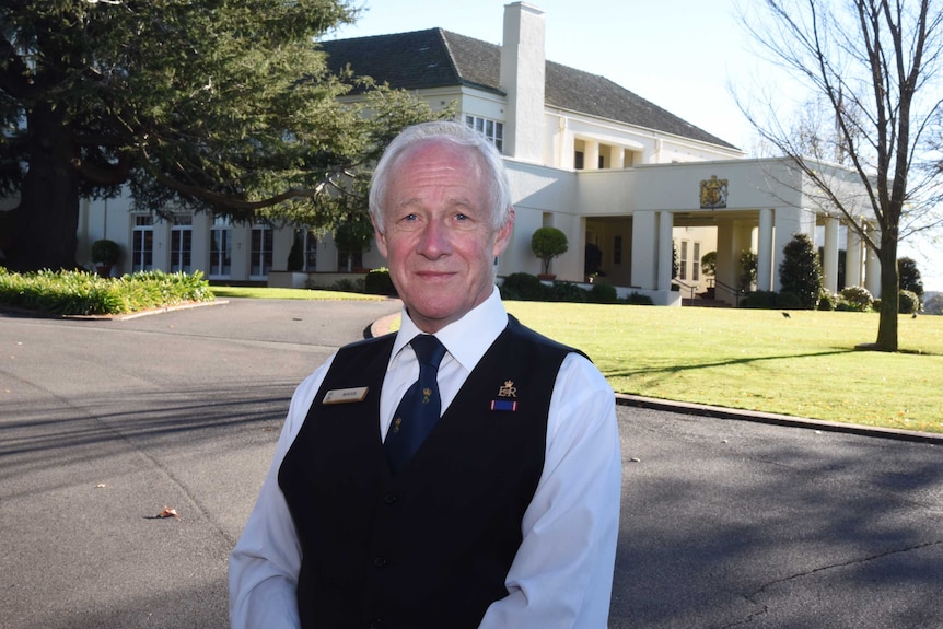 Roger King standing in front of Government House in Canberra.
