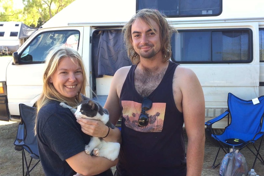 A photo of Toni Chambers and Joe Amour holding their cat Tinks.