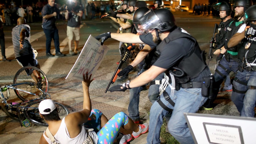 Police officers arrest a demonstrator in Ferguson, Missouri.