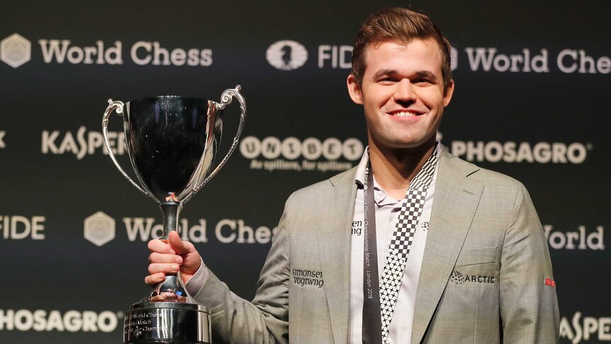 Magnus Carlsen lifts trophy after winning world chess championship