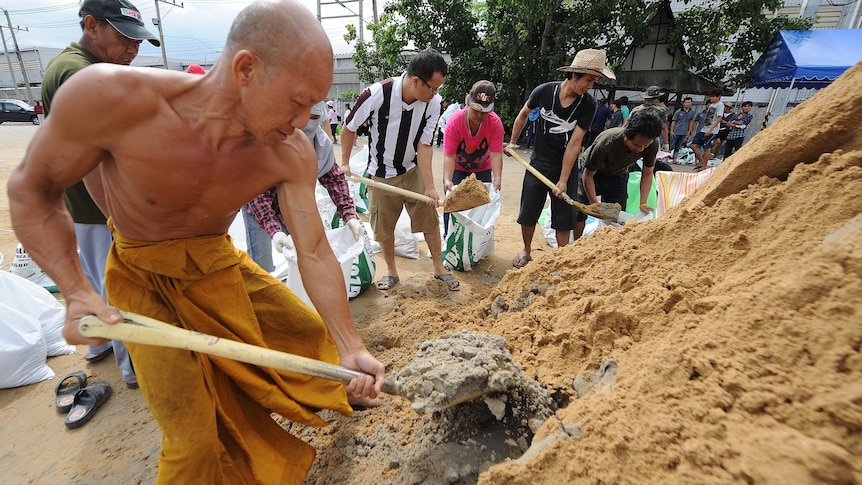 Thai residents prepare sandbags used to hold back floodwaters in Pathum Thani province.