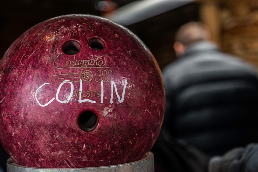 A bowling ball bearing the name 'Colin'.