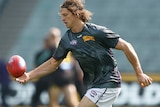 Nat Fyfe controls a ball while warming up before a game