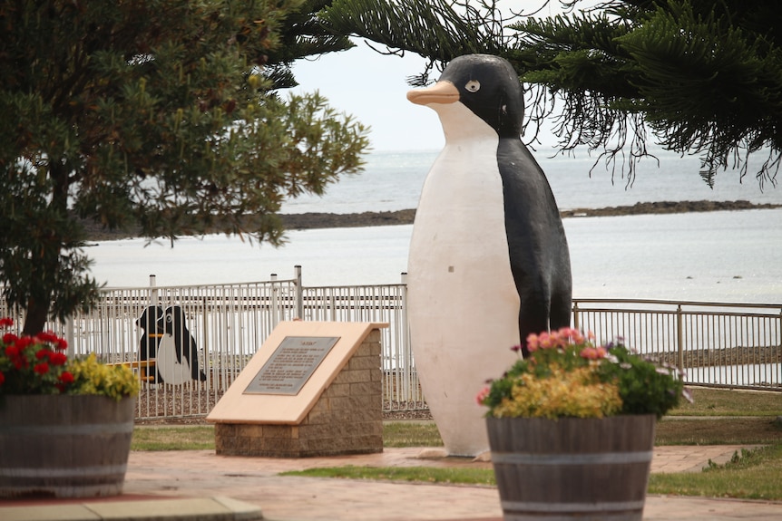 A large cement sculpture of a penguin