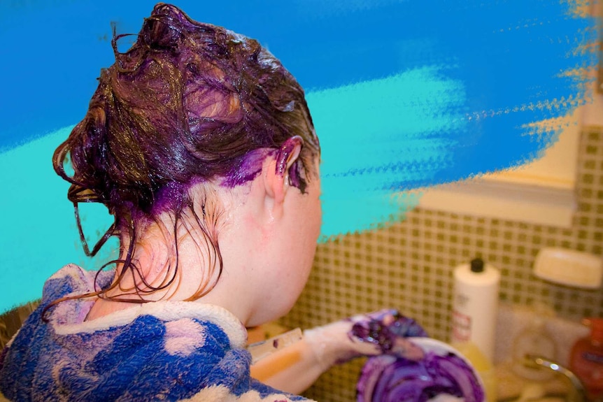 Back of a woman's head covered in purple hair dye