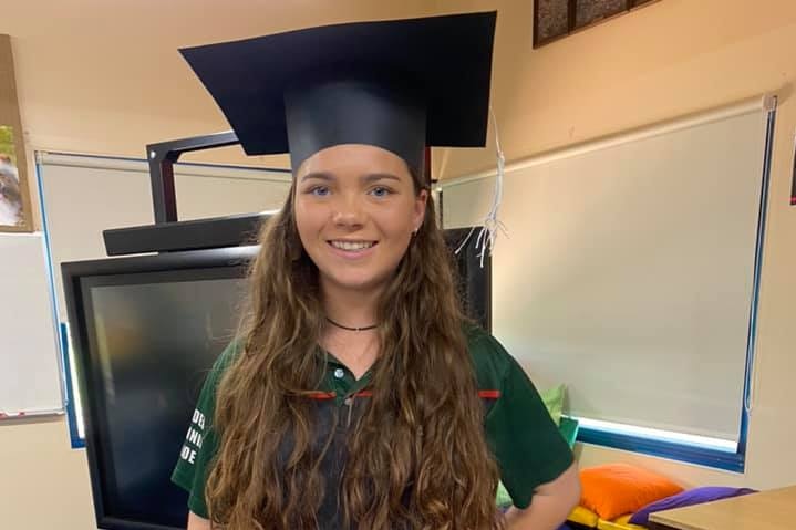 Year 12 student Kate Lauritsen-Graham cutting her graduation cake