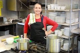 Food tech teacher Mandy Adams in the school kitchen with a tea towel over her shoulder.