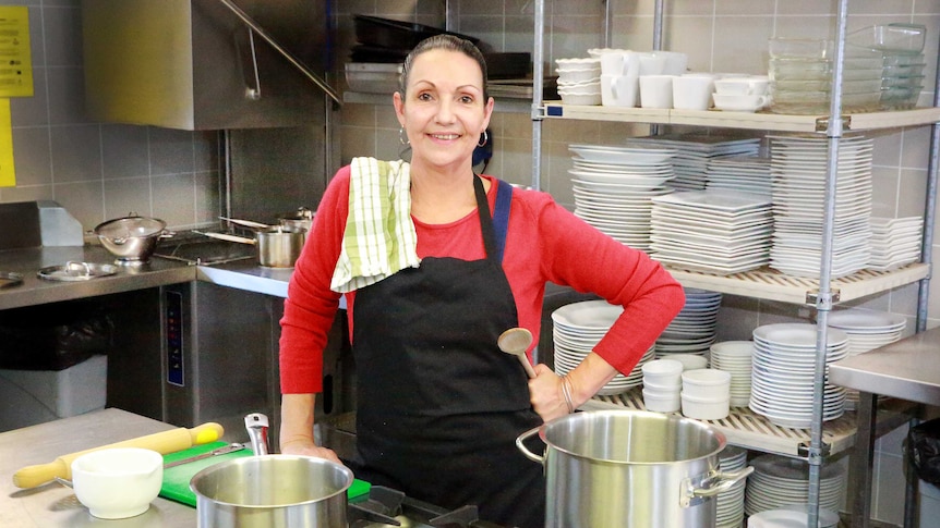 Food tech teacher Mandy Adams in the school kitchen with a tea towel over her shoulder.