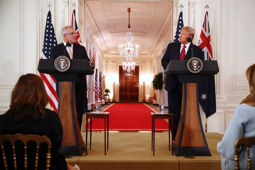 Australian Prime Minister Scott Morrison speaks as US President Donald Trump looks at him during a joint press conference.