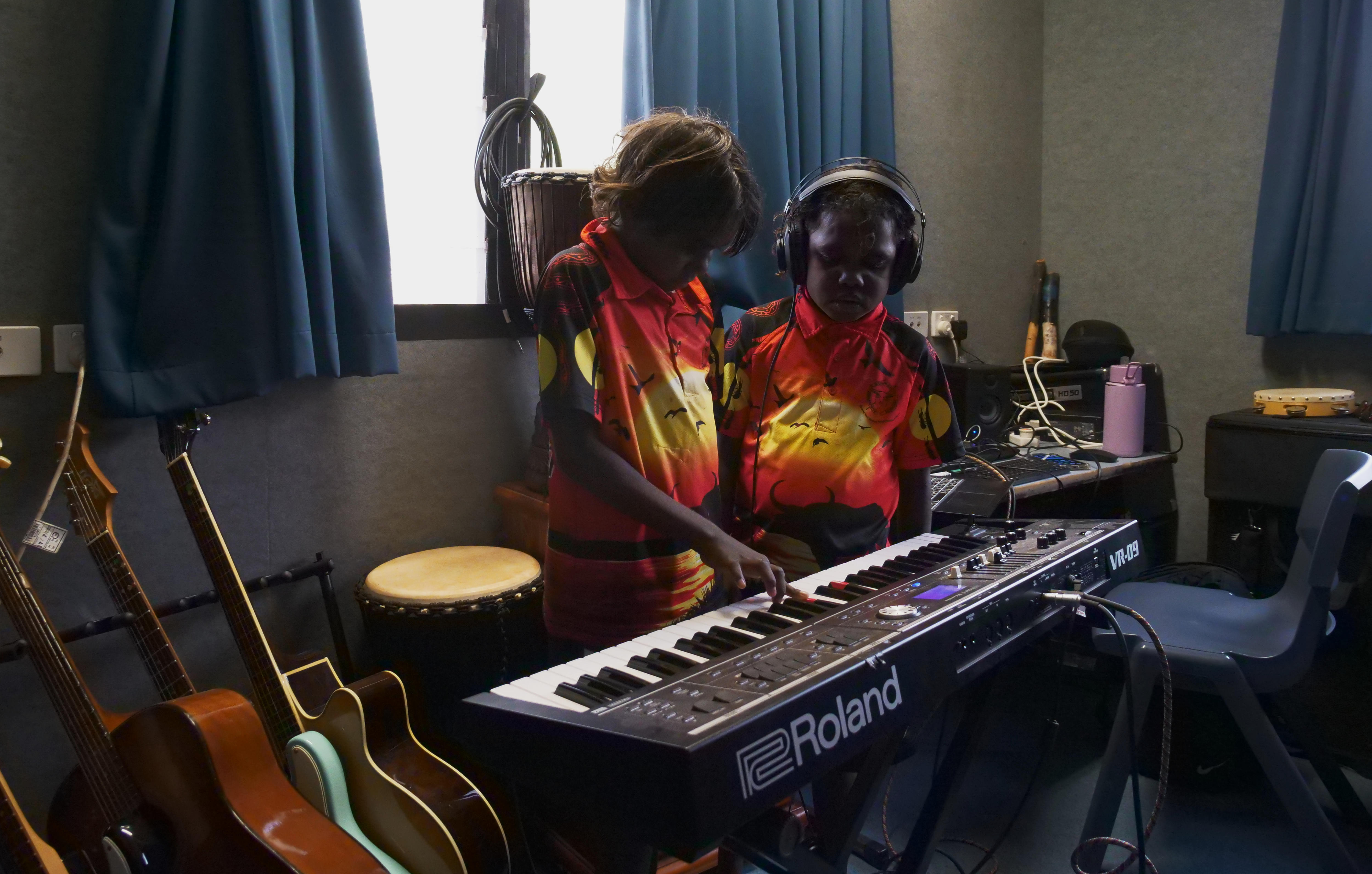 Two girls playing keyboard. 